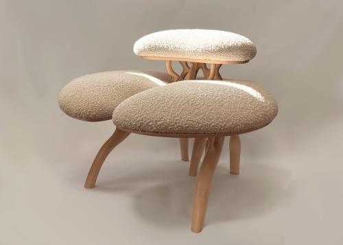 Two-tiered chair made from organically carved maple and upholstered in cream-colored boucle.

